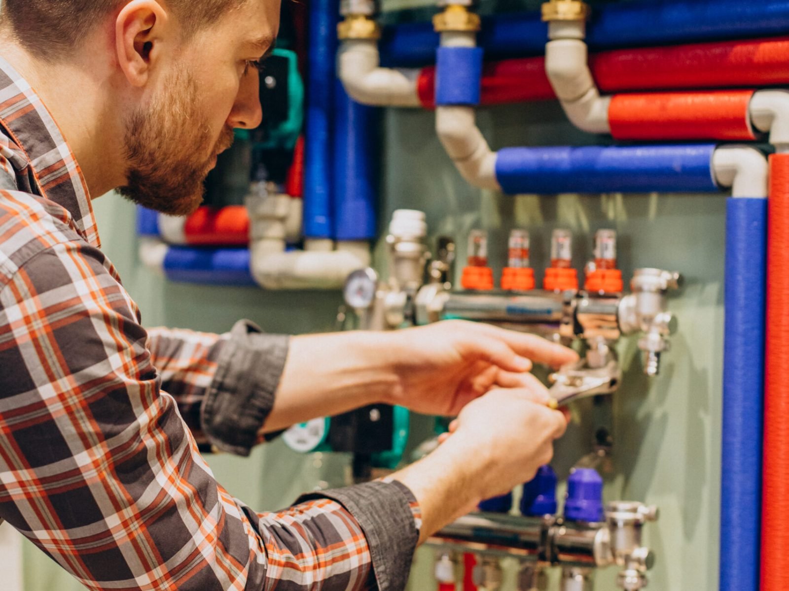 Young engineer adjusting autonomous heating